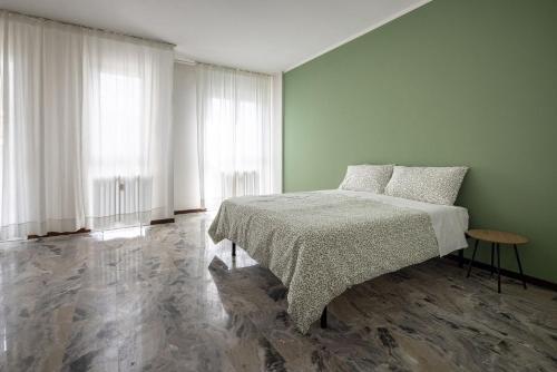 a bedroom with a bed and two large windows at Casa Genny in Padova