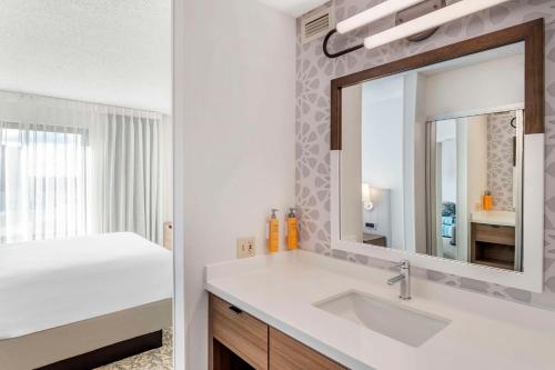 a bathroom with a sink and a mirror at Sonesta ES Suites San Antonio Downtown Alamo Plaza - Newly Renovated in San Antonio