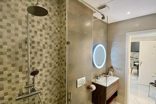 a bathroom with a shower and a sink at Central Large Suite with Balcony & Beach view in Tangier