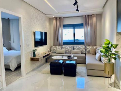 a living room with a couch and a bed at Central Large Suite with Balcony & Beach view in Tangier