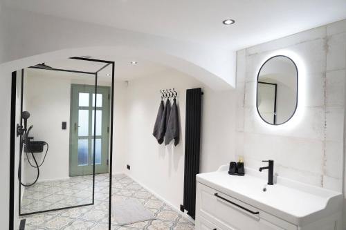 a bathroom with a sink and a mirror at Chalupa Velká Javorská in Žandov