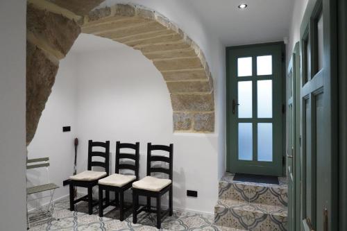 a group of chairs sitting in a room with a door at Chalupa Velká Javorská in Žandov