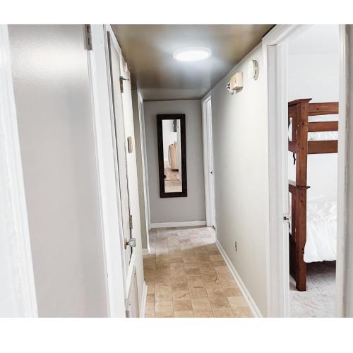 a hallway with a hallway leading to a bedroom at Comfortable Tuscaloosa Retreat in Tuscaloosa