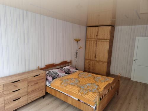 a bedroom with a bed and a dresser at Kaunas 174 in Kaunas
