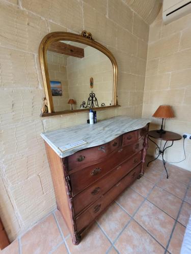 a bathroom with a sink and a mirror at UNDER NEW MANAGEMENT! Sant Antnin Luxurious Farmhouse Villa With Pool Sannat Near Victoria Gozo Family Friends Couples Views Balcony Roof Terrace Romantic Getaway in Munxar