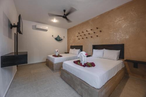 Letto o letti in una camera di Hotel Kuxtal