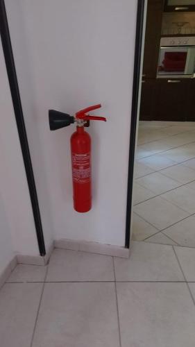 a red fire extinguisher hanging on a wall at La Piccola Valle in Vallefiorita