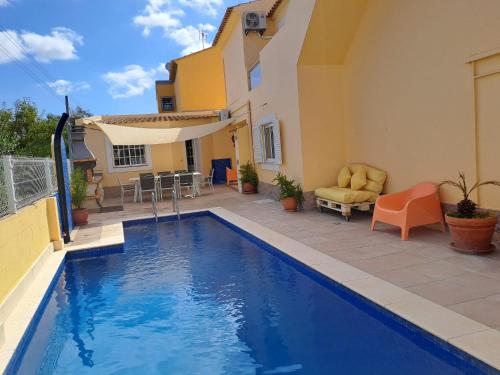 a swimming pool in front of a house at vila pinheiro in Bias do Norte