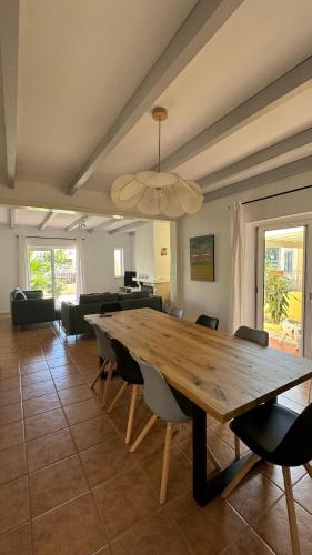 a dining room with a wooden table and chairs at vila pinheiro in Bias do Norte
