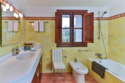une salle de bains avec lavabo, baignoire et toilettes dans l'établissement Doppelzimmer Vendaval Es Llobets, à Llucmajor