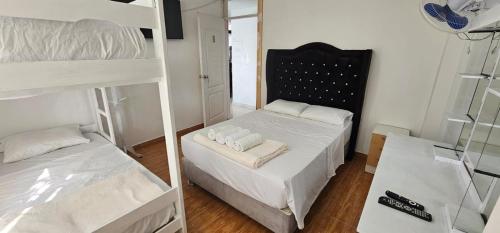 a bedroom with two bunk beds and a mirror at Pacharodeo & Hospedaje in Pachacamac