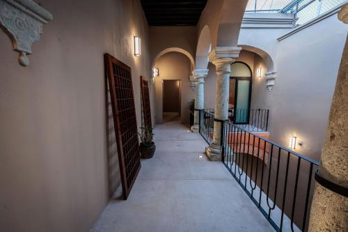 a hallway of a building with columns and a door at Casa 1800 Oaxaca Boutique Hotel City Center based in Oaxaca City