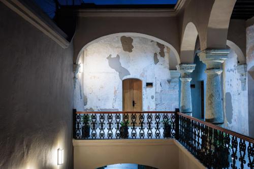 a hallway with a staircase in a building at Casa 1800 Oaxaca Boutique Hotel City Center based in Oaxaca City