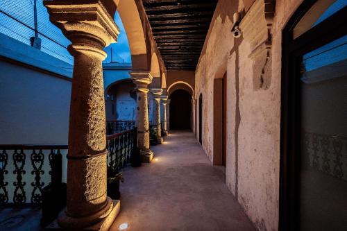 an empty hallway with columns in a building at Casa 1800 Oaxaca Boutique Hotel City Center based in Oaxaca City