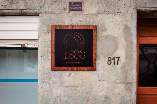 a sign on the side of a building at Casa 1800 Oaxaca Boutique Hotel City Center based in Oaxaca City