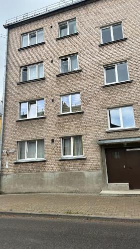 a brick building with a garage on the side of it at AC apartaments Daugavpils Central in Daugavpils
