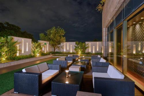 a bar with chairs and tables in front of a building at Crowne Plaza Kochi by IHG in Cochin