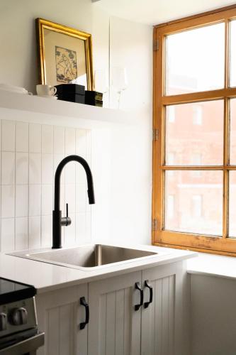 a kitchen with a sink and a window at Maison Rasco by Luxury In Transit in Montréal