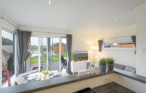 a kitchen and living room with a large window at Chalet Sonnenschein in Süsel