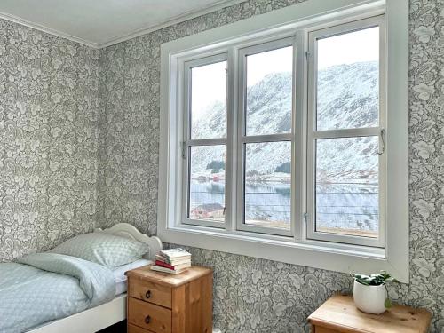 a bedroom with a bed and a window at Lofoten Fjord House - Mountain & Seaview in Ramberg