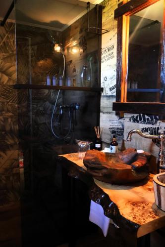 a bathroom with a wooden sink and a mirror at Divlja Orhideja in Sunja