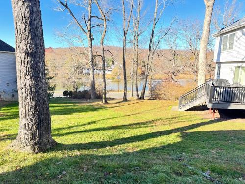 a yard with a tree and a house at Panoramic Lakeview Suite Ultimate Comfort and Serenity in Watchung