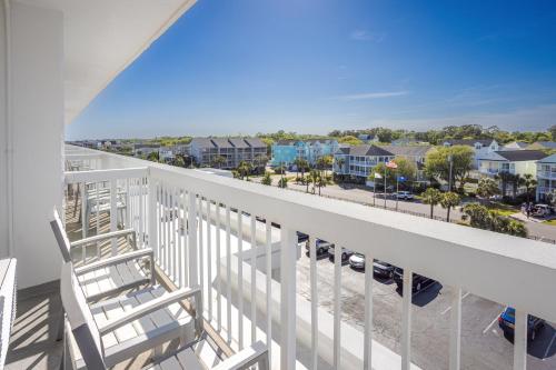 a balcony with chairs and a view of a street at Holiday Inn Resort Oceanfront at Surfside Beach by IHG in Myrtle Beach