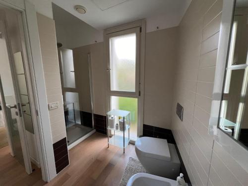 a bathroom with a toilet and a sink and a window at Casa al mare Pula in Pula