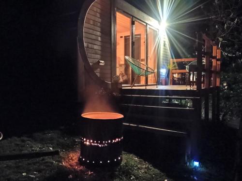a house with a fire pit in the yard at night at Timber Cabin in Selby near Puffing Billy in Selby