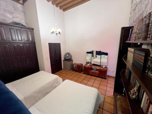 a bedroom with two beds and a mirror at Casa monarca in Morelia