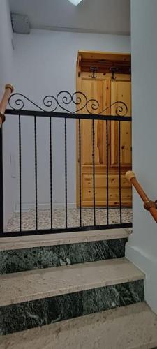 a iron railing on a staircase with a door at La Sosta in Arliod