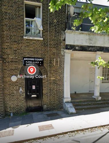 anagency court sign on the side of a brick building at Archway Court in London