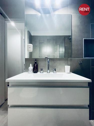 a bathroom with a white sink and a mirror at Rent Aguero in Buenos Aires