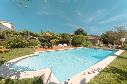 a swimming pool in the yard of a house at Quinta Sao Miguel de Arcos in Vila do Conde