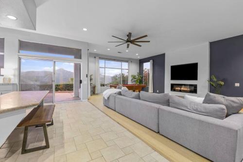 a living room with a large couch and a tv at Massive 7BR Stunning MTN View Zen Retreat Pool and Spa in Ramona