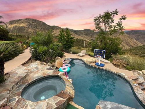 a large swimming pool in a backyard with a mountain at Massive 7BR Stunning MTN View Zen Retreat Pool and Spa in Ramona