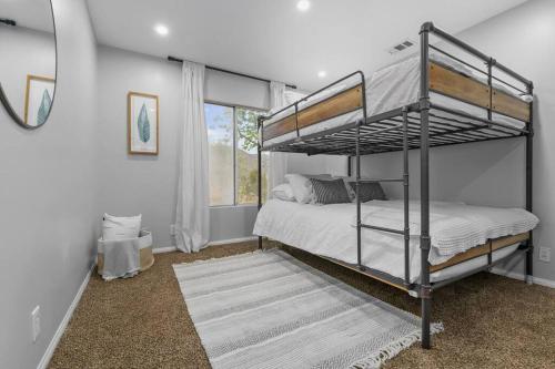 a bedroom with two bunk beds and a window at Massive 7BR Stunning MTN View Zen Retreat Pool and Spa in Ramona