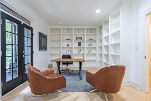 an office with a desk and chairs in a room at The Black House At Victoria Mill Buckhead in Atlanta