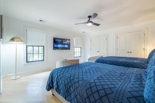 a bedroom with two beds and a tv on the wall at The Black House At Victoria Mill Buckhead in Atlanta