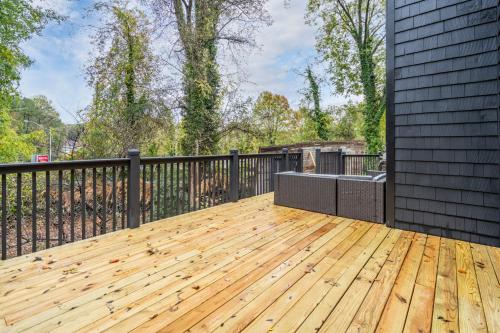 a large wooden deck with a black fence at The Black House At Victoria Mill Buckhead in Atlanta