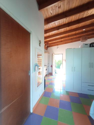a hallway with a colorful floor in a house at Casa quinta frente al Balneario in Azul