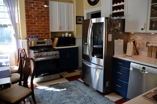 a kitchen with a stainless steel refrigerator and a stove at The Kings Throne Inn and Guest House in Toledo