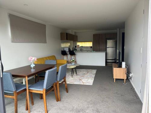 a kitchen and dining room with a table and chairs at The perfect Christchurch Escape in Christchurch