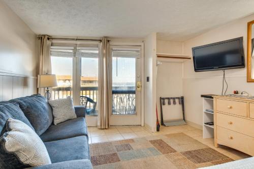 a living room with a blue couch and a tv at Beachfront 15 Condo on Old Orchard Beach in Old Orchard Beach