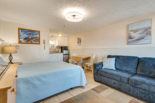 a bedroom with a blue bed and a couch at Beachfront 15 Condo on Old Orchard Beach in Old Orchard Beach