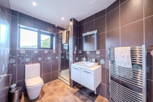 a bathroom with a toilet and a sink at Over Lane in Almondsbury