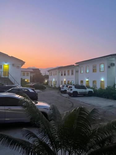 a group of cars parked in a parking lot at Pousada Fortaleza in Paraty