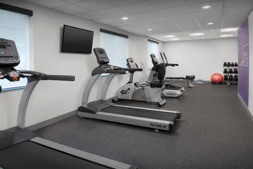 a gym with cardio machines and a flat screen tv at Holiday Inn Express Spokane Airport by IHG in Spokane