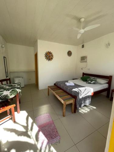 a room with a bed and a bench in it at Pousada Fortaleza in Paraty