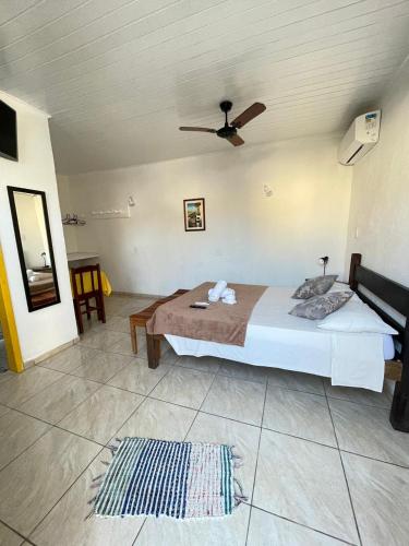 a bedroom with a bed and a ceiling fan at Pousada Fortaleza in Paraty